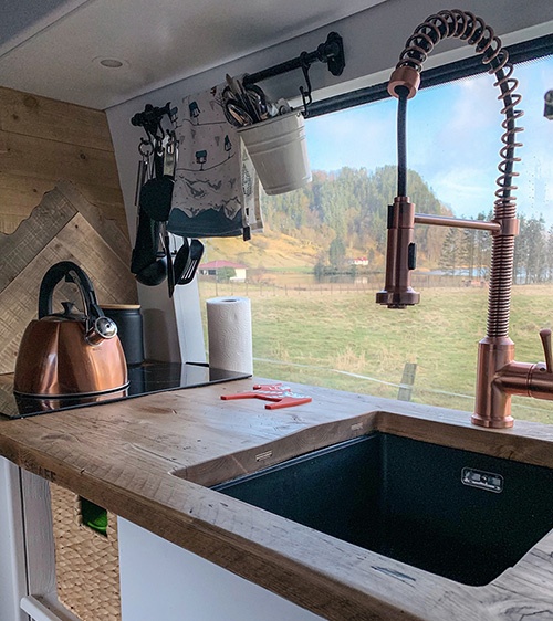 our campervan kitchen with copper kettle and copper tap