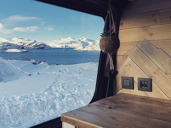 Snowy view over Lofoten in Norway out our our van window where campervan heating was essential!