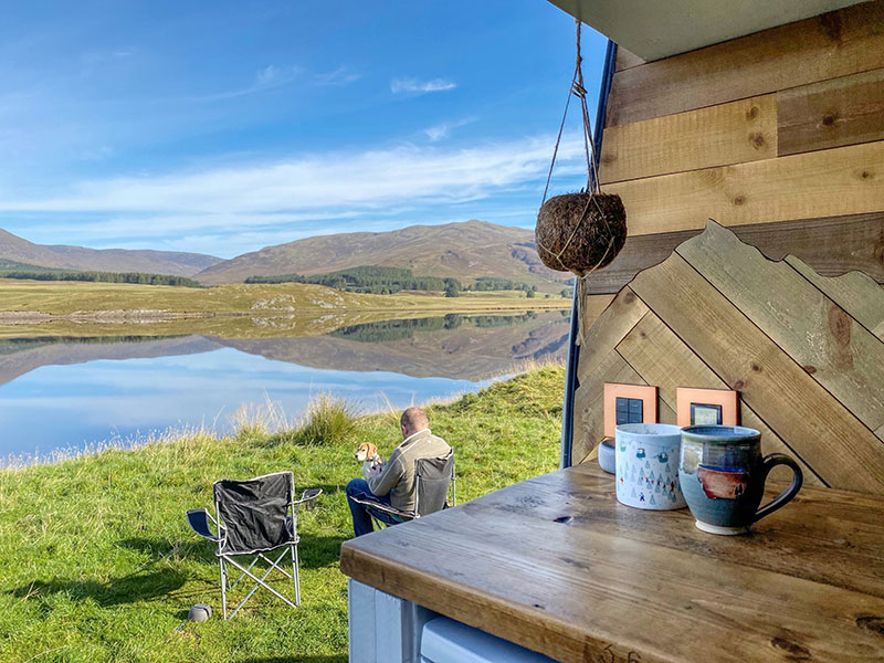 Admiring the morning view of a loch from our van