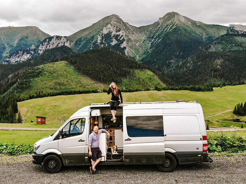 Us, our van and the Tatra Mountains at a free campervan parking spot in Slovakia