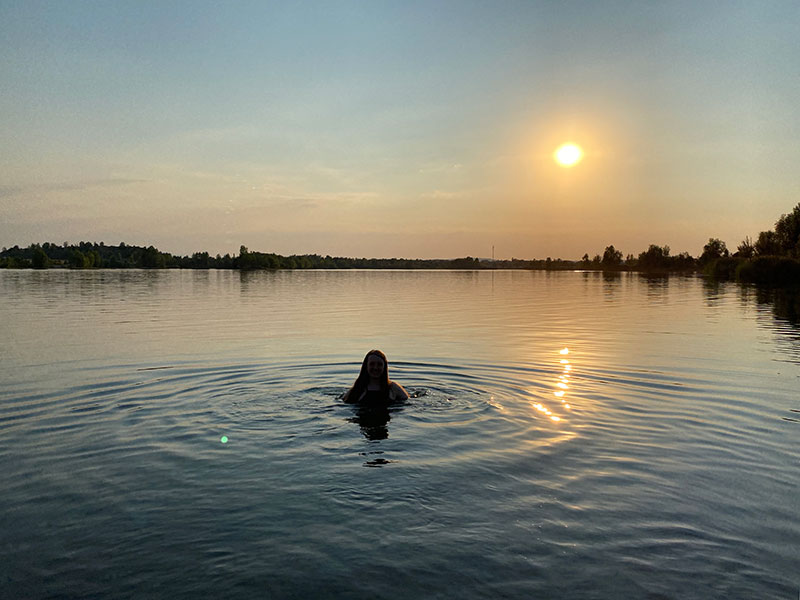 Swimming in Goringer See lake at sun set