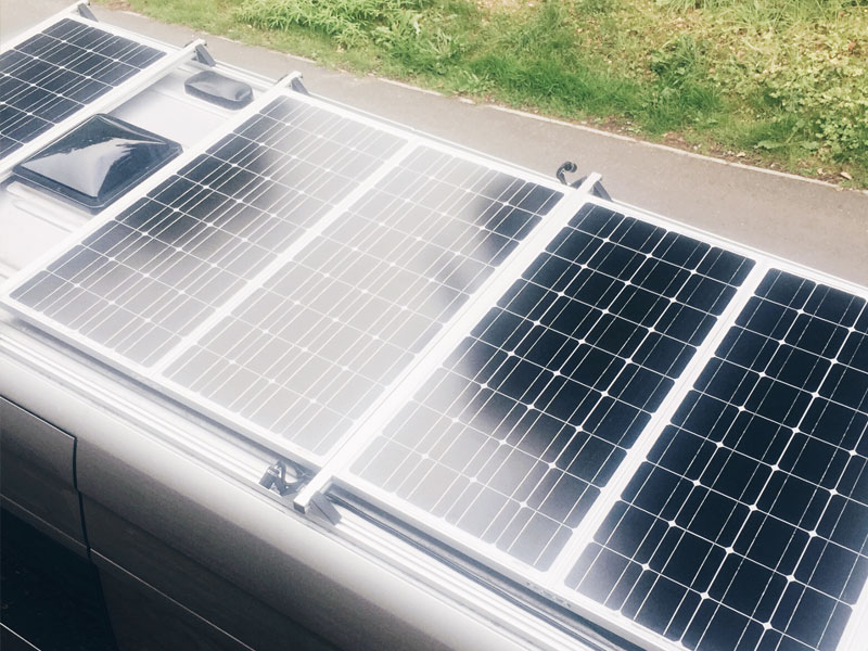 The roof of our camper van with a Fantastic Fan and 5 solar panels