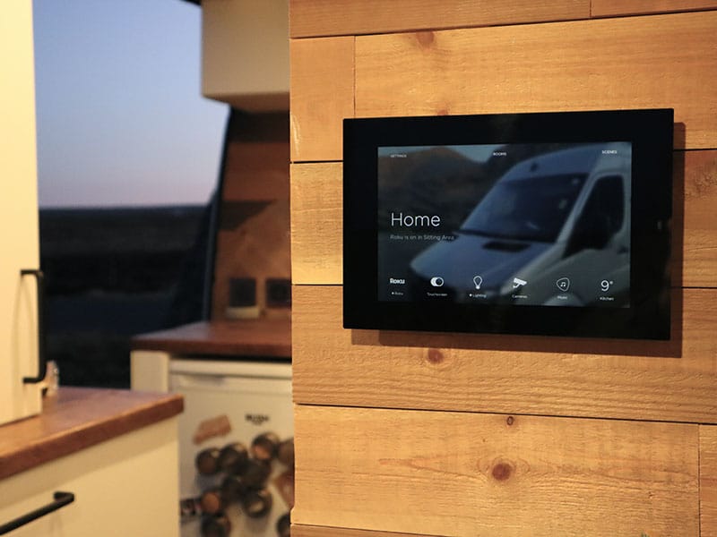 Savant touchscreen in our van showing how our van life tech links together on one screen