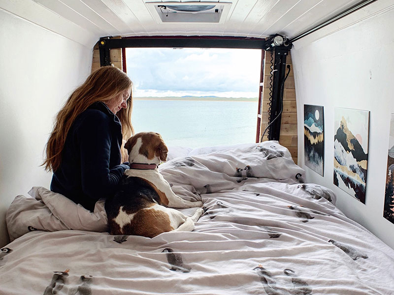 Piglet and I sitting on Happijac bed looking out over ocean with rear fan above