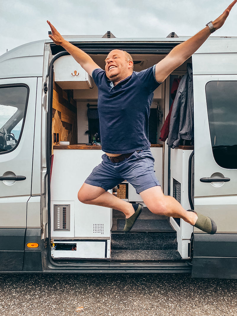 Jumping out of campervan in outdoor slippers