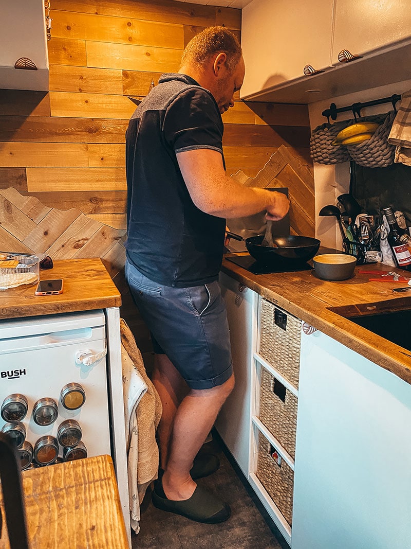 Wearing camping slippers to cook inside self converted Sprinter van